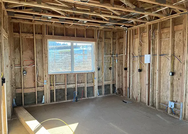 Interior home under construction with visible wiring